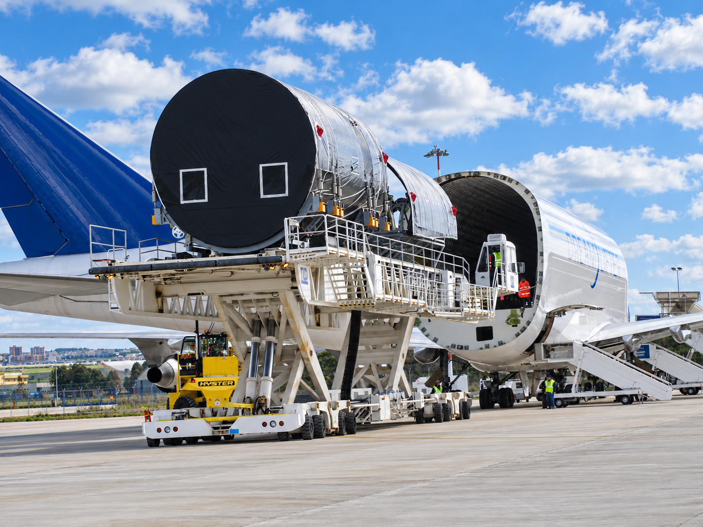 Oversized industrial cargo being loaded into a cargo aircraft